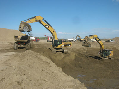excavator and truck moving dirt