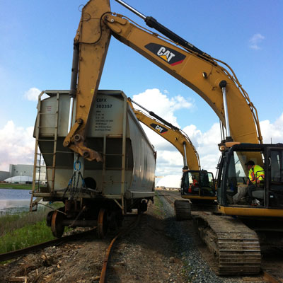 escavator dumping dirt into truck